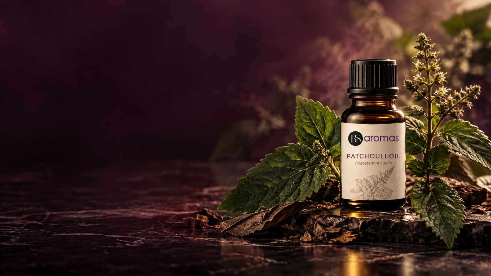 Amber Patchouli Essential Oil bottle with patchouli leaves